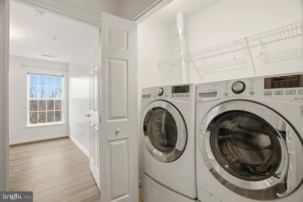 a view of a hallway with washer and dryer