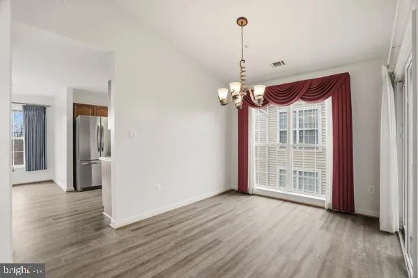a view of a room with wooden floor and windows