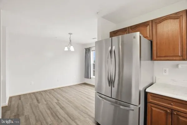 a view of a kitchen with wooden floor and electronic appliances