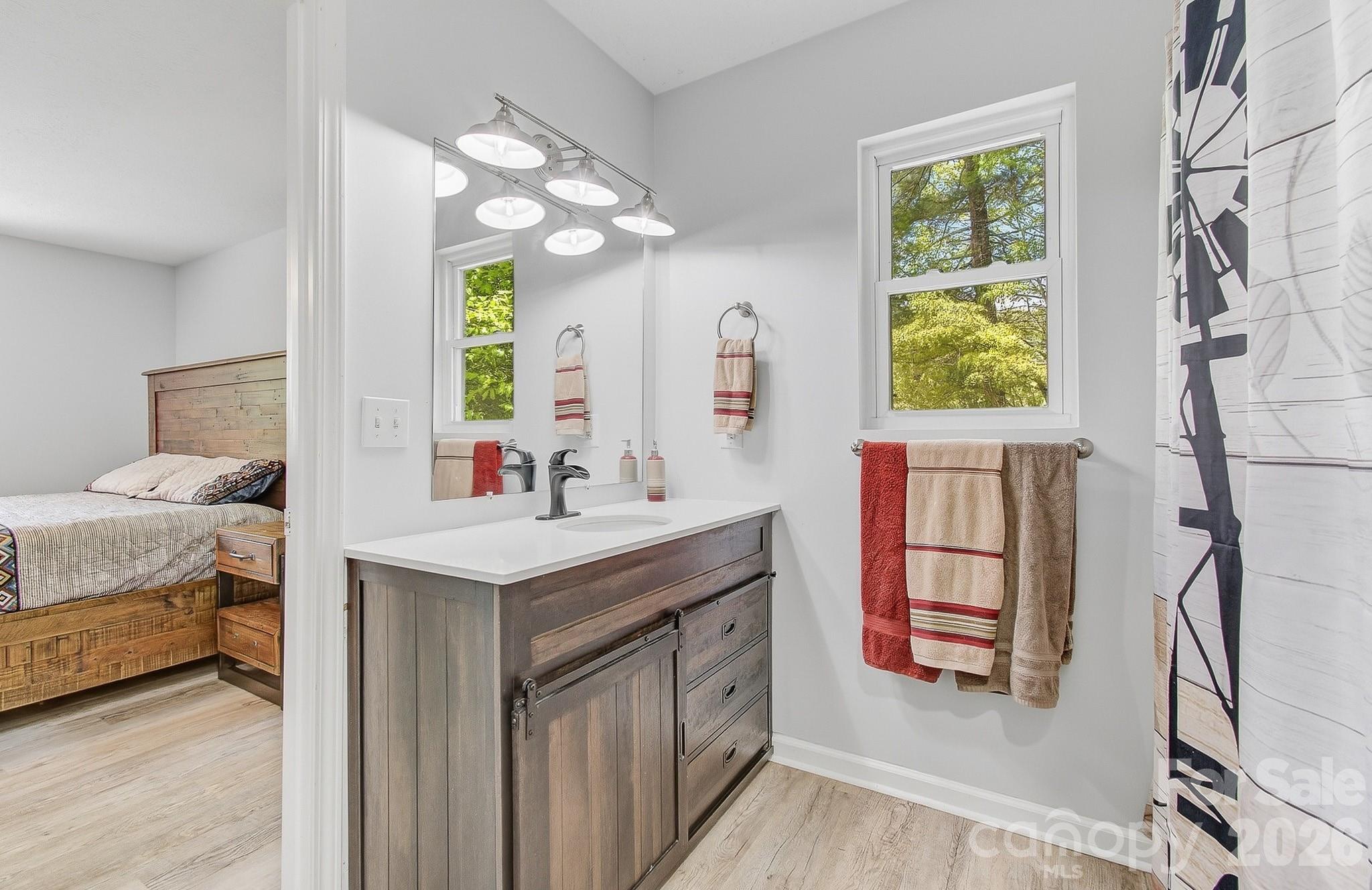 2131 Coleman Mountain Road Waynesville, NC 28785 - Photo 17 of 40 a bathroom with a sink double vanity and a mirror