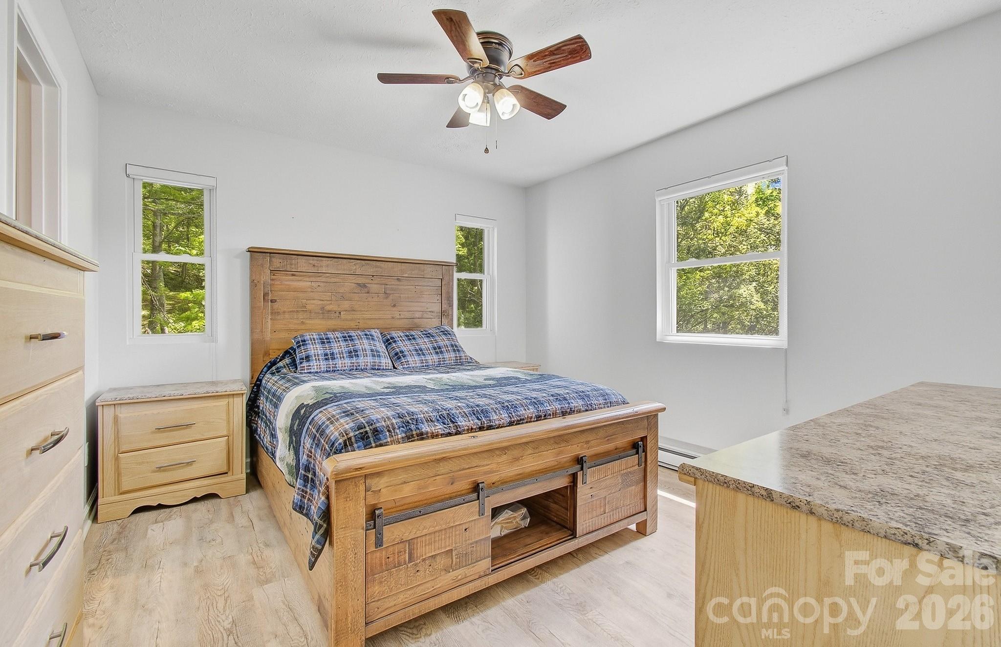 2131 Coleman Mountain Road Waynesville, NC 28785 - Photo 19 of 40 a bedroom with a bed and a window