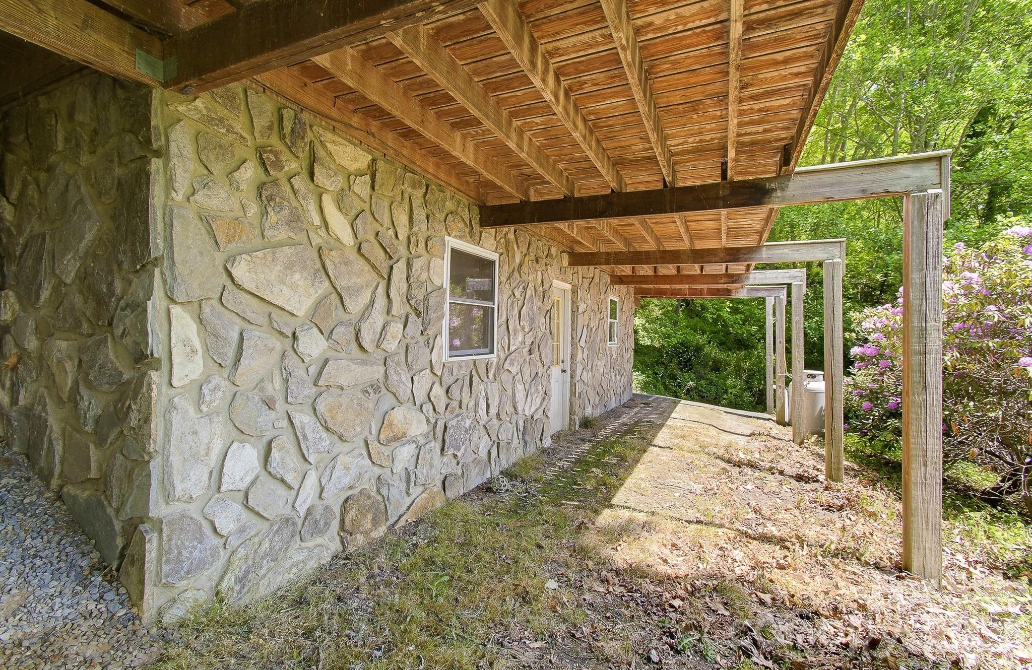 2131 Coleman Mountain Road Waynesville, NC 28785 - Photo 37 of 40 a view of a backyard with wooden fence and a porch