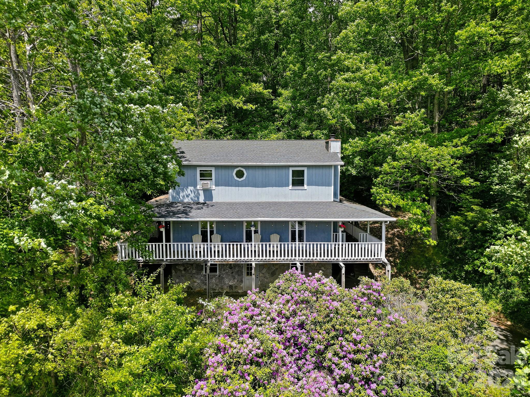 2131 Coleman Mountain Road Waynesville, NC 28785 - Photo 38 of 40 front view of a house with a garden