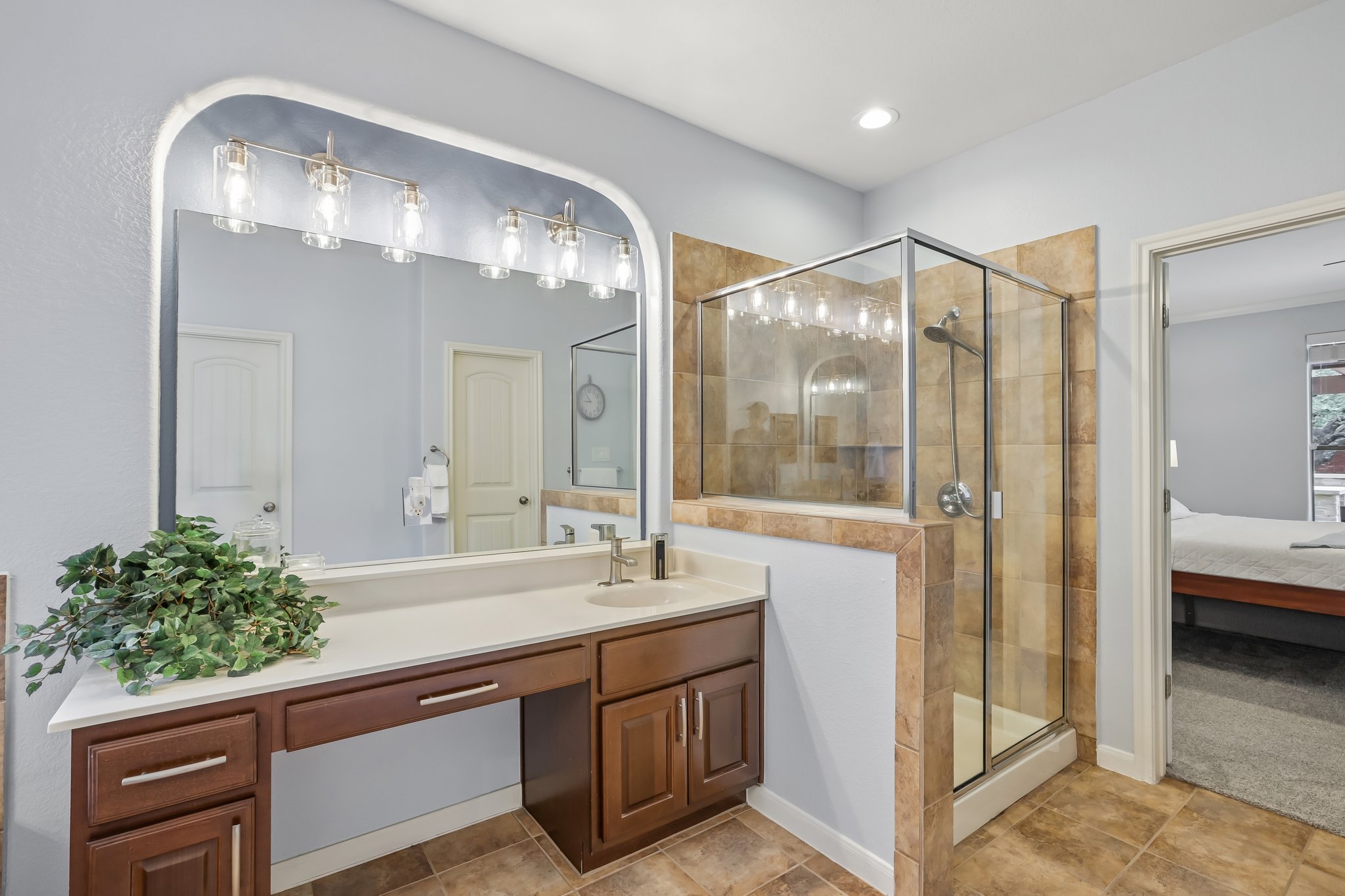 2023 Nelson Ranch Loop Cedar Park, TX 78613 - Photo 25 of 40 A well-appointed primary bathroom features a spacious vanity and a tiled walk-in shower.