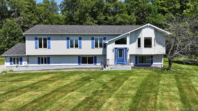 a front view of a house with a garden and yard