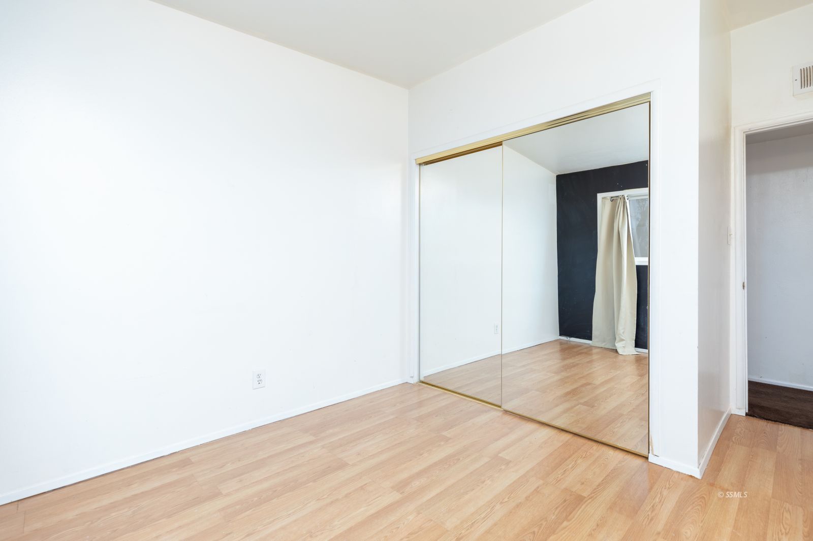 1263 South Primrose Street Ridgecrest, CA 93555 - Photo 23 of 36 a view of a big room with closet and wooden floor