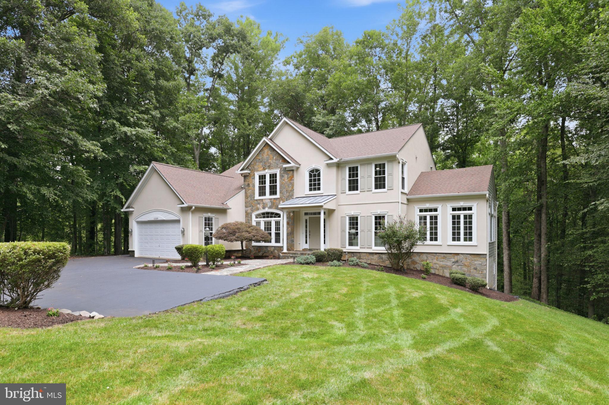 11509 Summit Ridge Court Manassas, VA 20112 - Photo 1 of 43 a front view of a house with a garden and trees