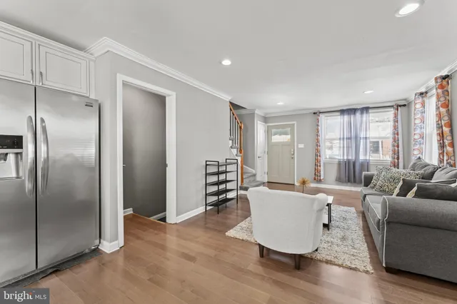 a living room with furniture and large windows