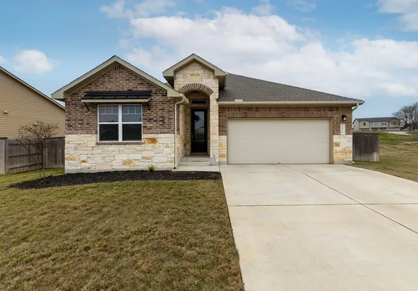 a front view of a house with garage