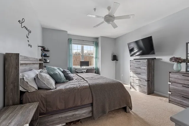 a bedroom with a bed and a television