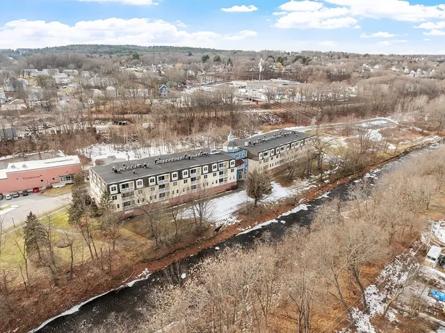 a view of a wooden fence under a large tree