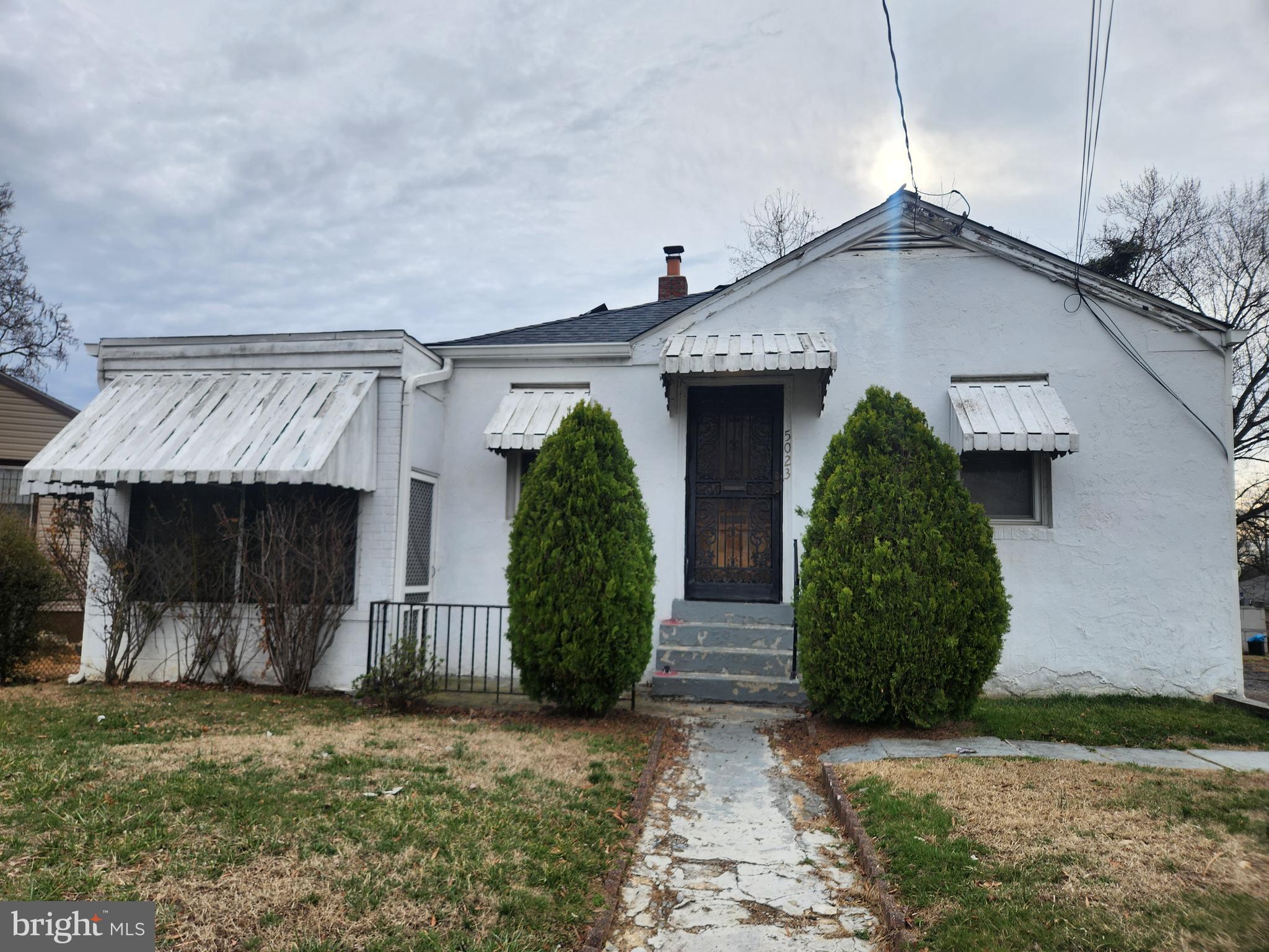 5023 Addison Road Capitol Heights, MD 20743 - Photo 13 of 17 a front view of house with garden
