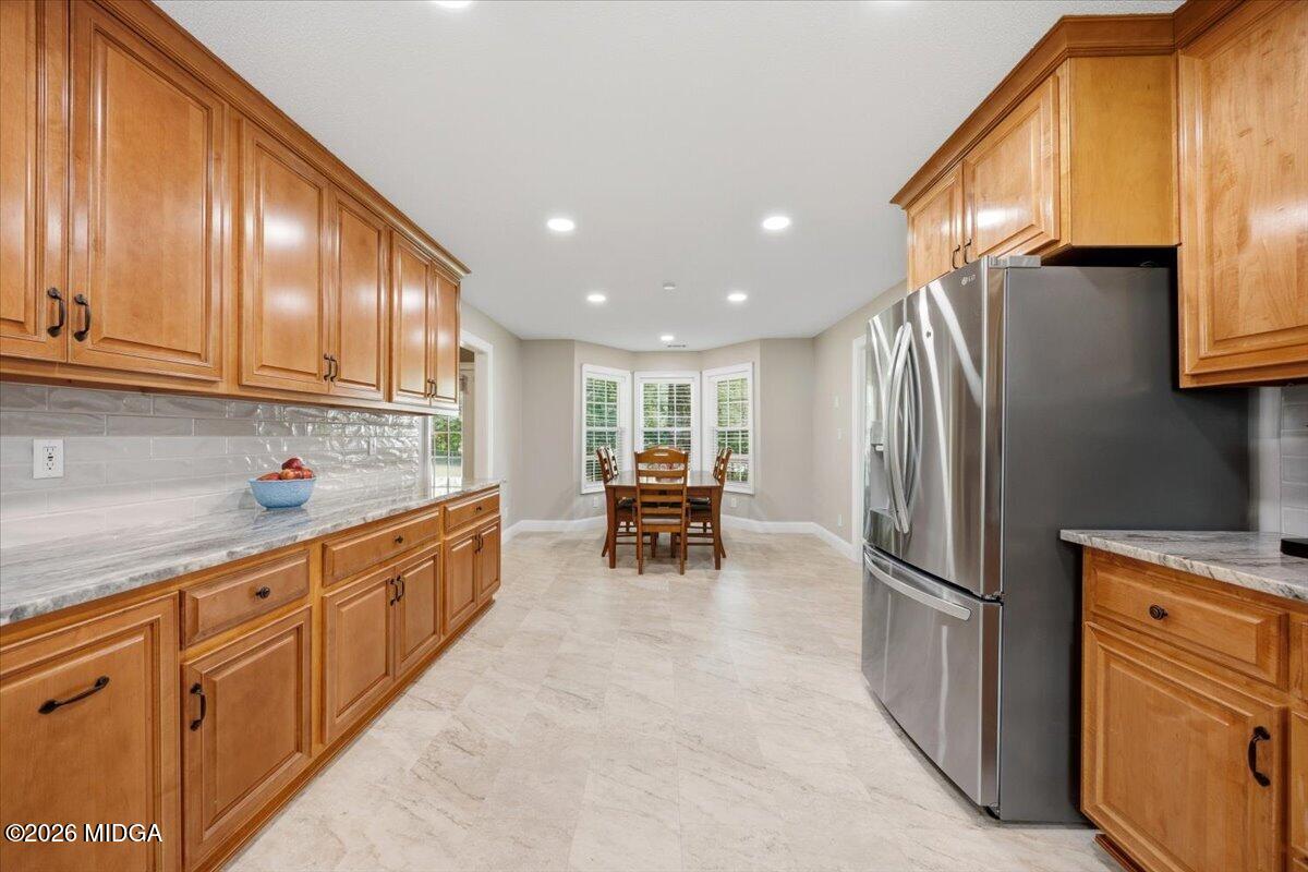 557 Aarons Circle Gray, GA 31032 - Photo 13 of 36 a kitchen with stainless steel appliances granite countertop a refrigerator and cabinets