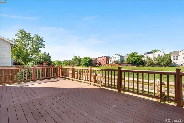 a balcony with wooden floor and fence