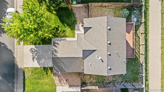 an aerial view of a house with a yard and sitting space