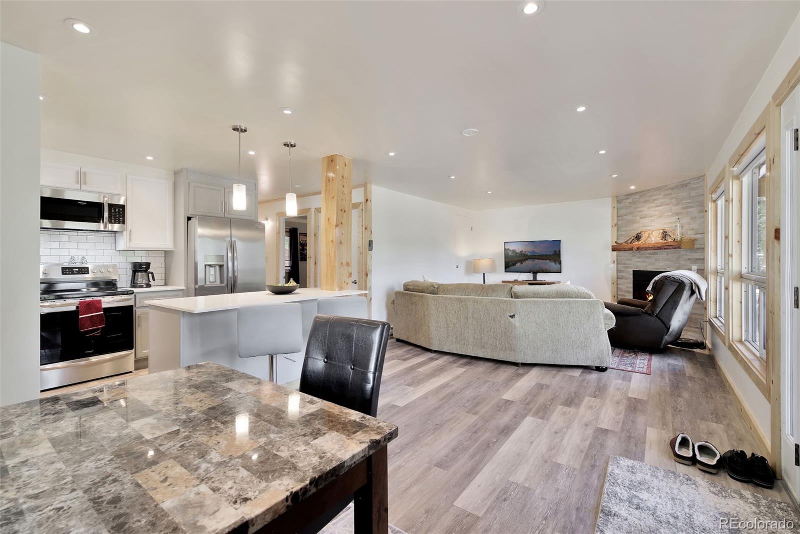 27320 Moonlight Way Steamboat Springs, CO 80487 - Photo 2 of 37 a large kitchen with cabinets wooden floor and stainless steel appliances