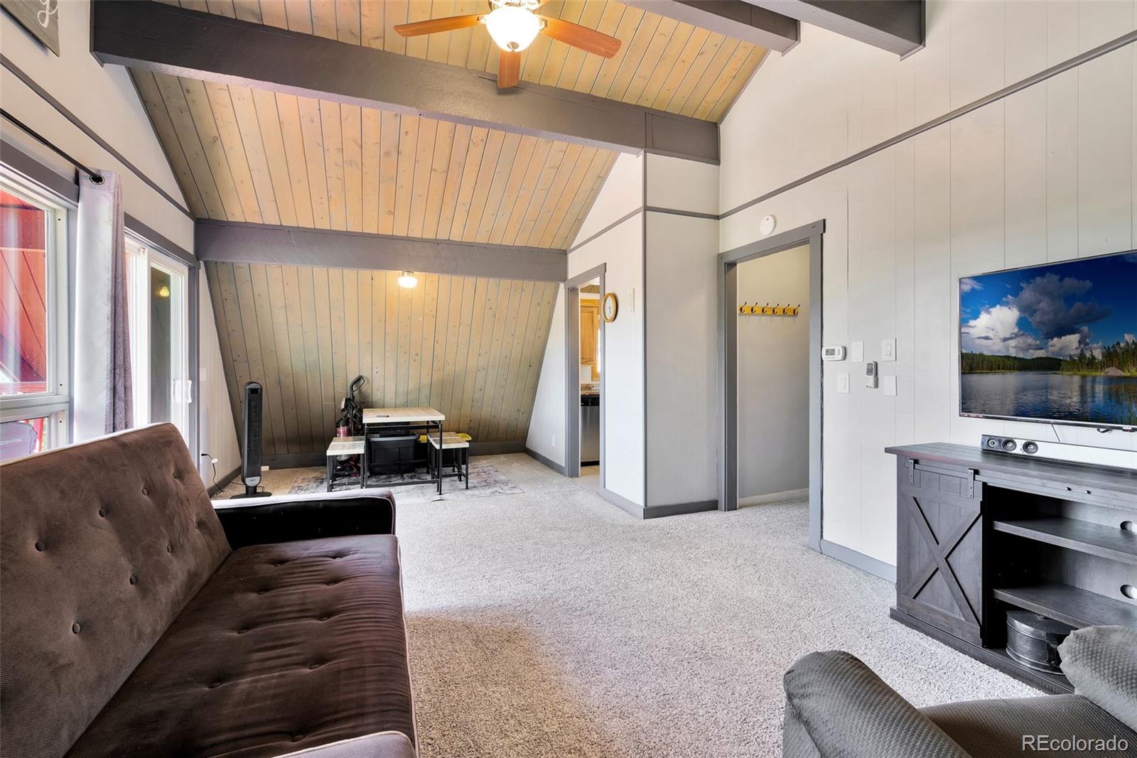 27320 Moonlight Way Steamboat Springs, CO 80487 - Photo 29 of 37 a living room with furniture and a flat screen tv