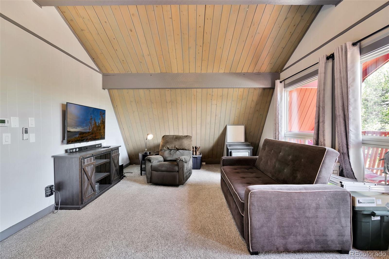 27320 Moonlight Way Steamboat Springs, CO 80487 - Photo 32 of 37 a living room with furniture and a flat screen tv
