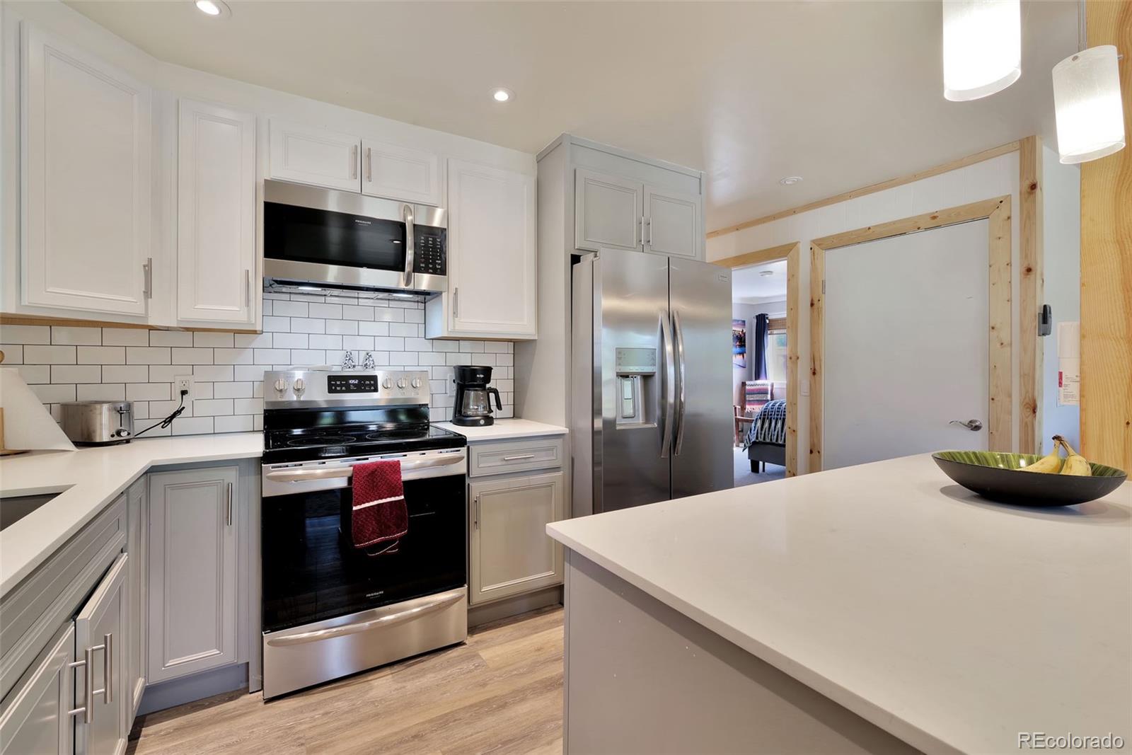 27320 Moonlight Way Steamboat Springs, CO 80487 - Photo 4 of 37 a kitchen with stainless steel appliances a stove microwave and sink