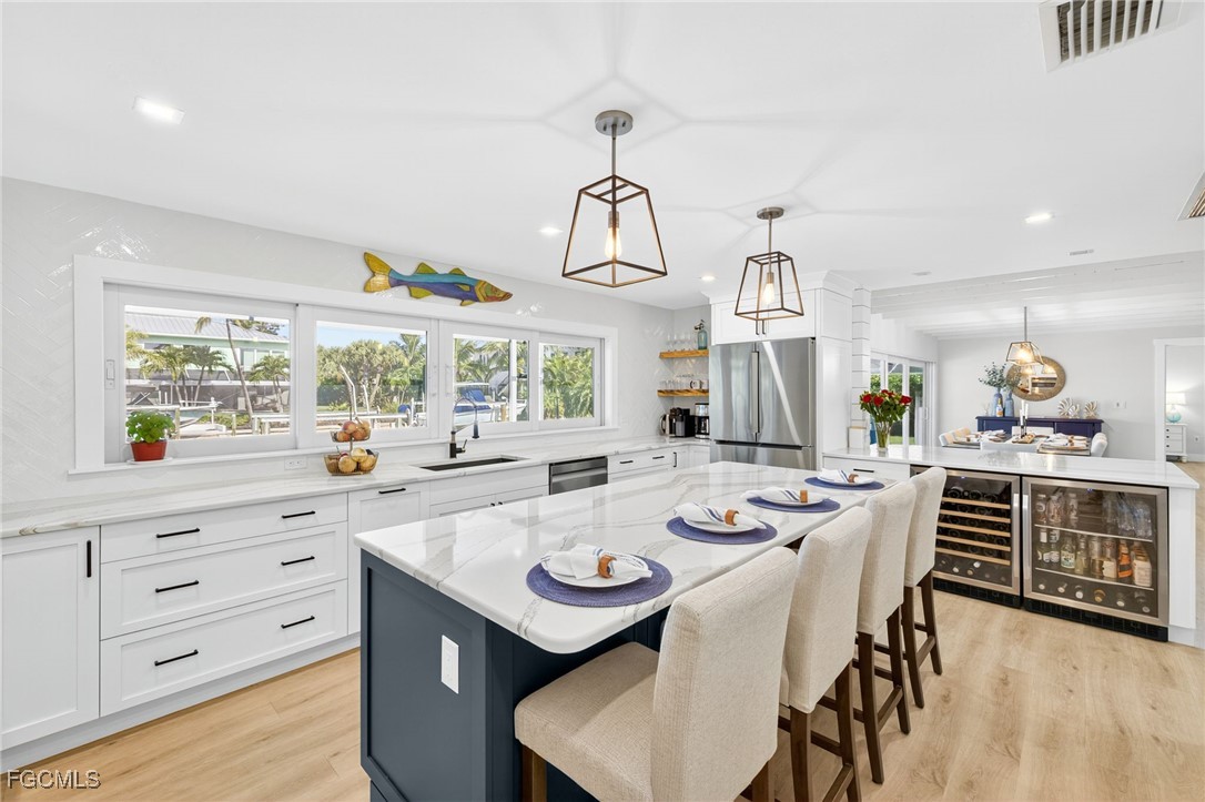 941 Pecten Court Sanibel, FL 33957 - Photo 22 of 44 a view of a dining room with furniture and wooden floor