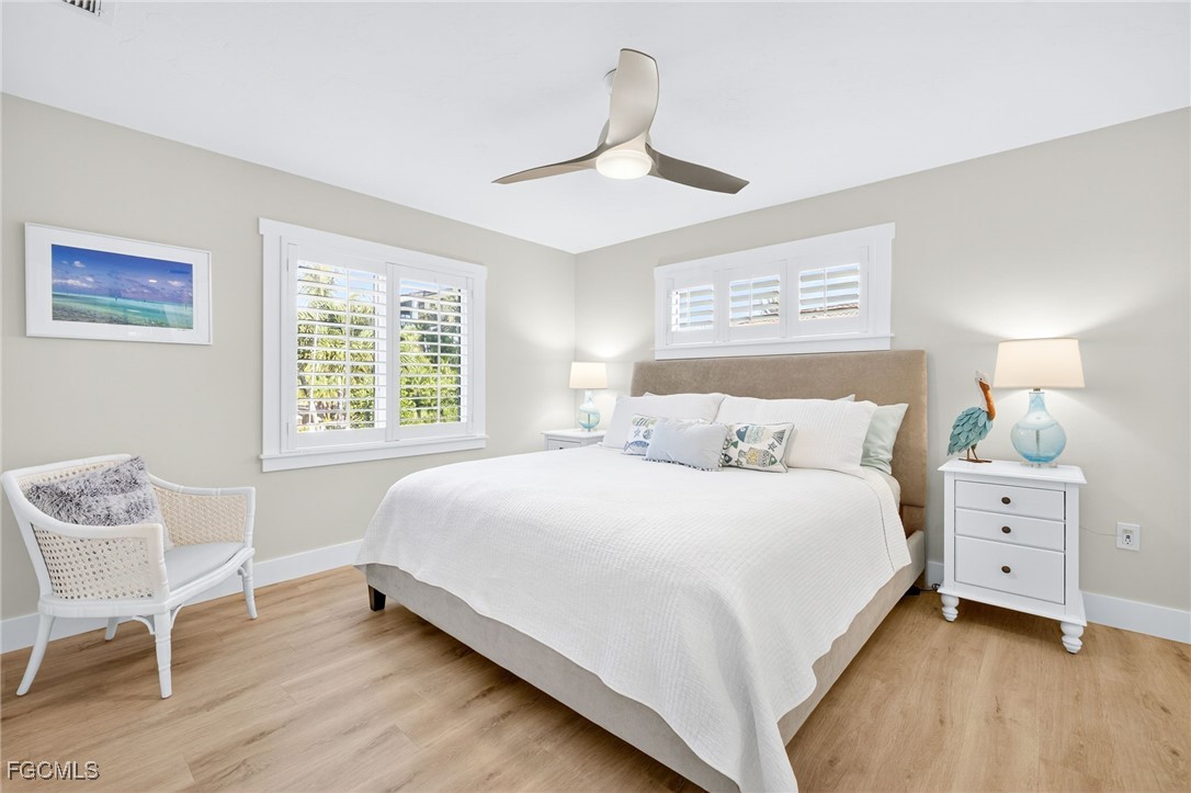 941 Pecten Court Sanibel, FL 33957 - Photo 25 of 44 a bedroom with a bed and a chair