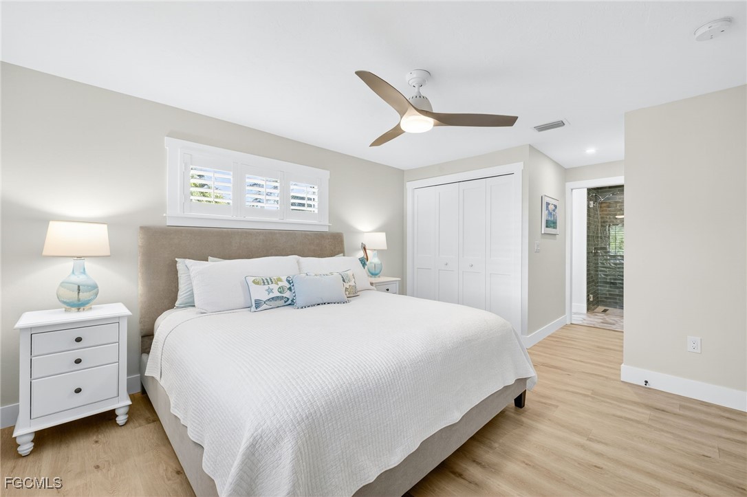 941 Pecten Court Sanibel, FL 33957 - Photo 27 of 44 a bedroom with a large bed and a night stand