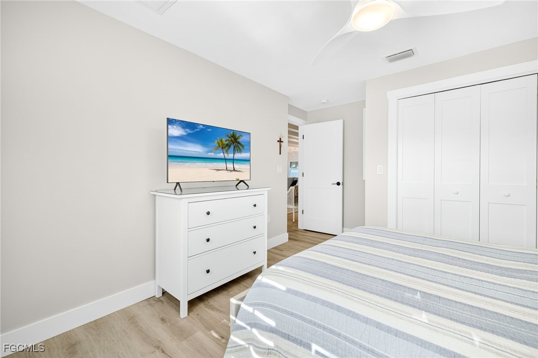 941 Pecten Court Sanibel, FL 33957 - Photo 31 of 44 a bedroom with a bed and a dresser in it