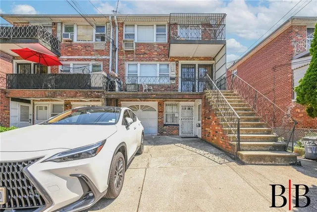 a view of a house with a patio and a yard