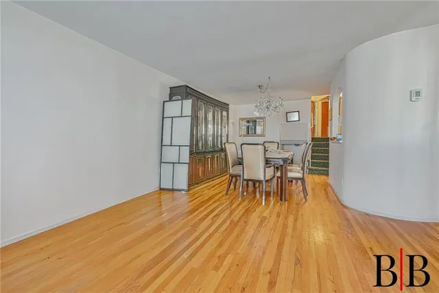a view of a room with furniture and wooden floor