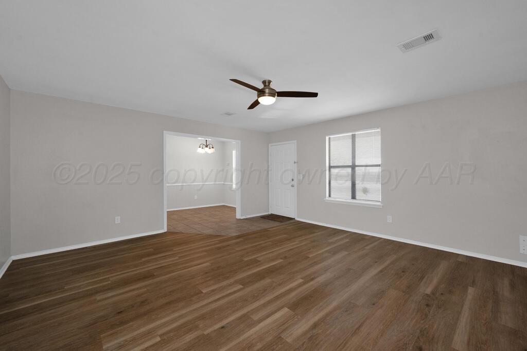 4200 South Austin Street, Unit B Amarillo, TX 79110 - Photo 3 of 13 a view of empty room with wooden floor and fan