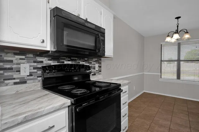 a kitchen with stainless steel appliances a stove a microwave and cabinets