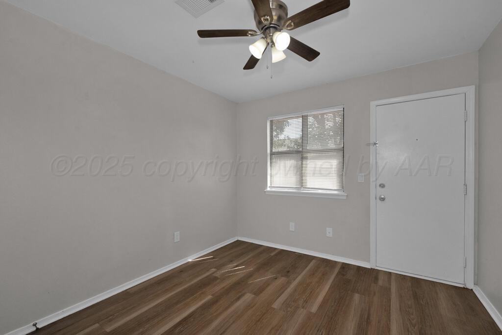4200 South Austin Street, Unit B Amarillo, TX 79110 - Photo 8 of 13 wooden floor in an empty room with a window