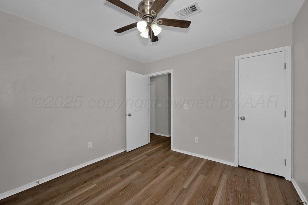 4200 South Austin Street, Unit B Amarillo, TX 79110 - Photo 9 of 13 a view of an empty room with wooden floor