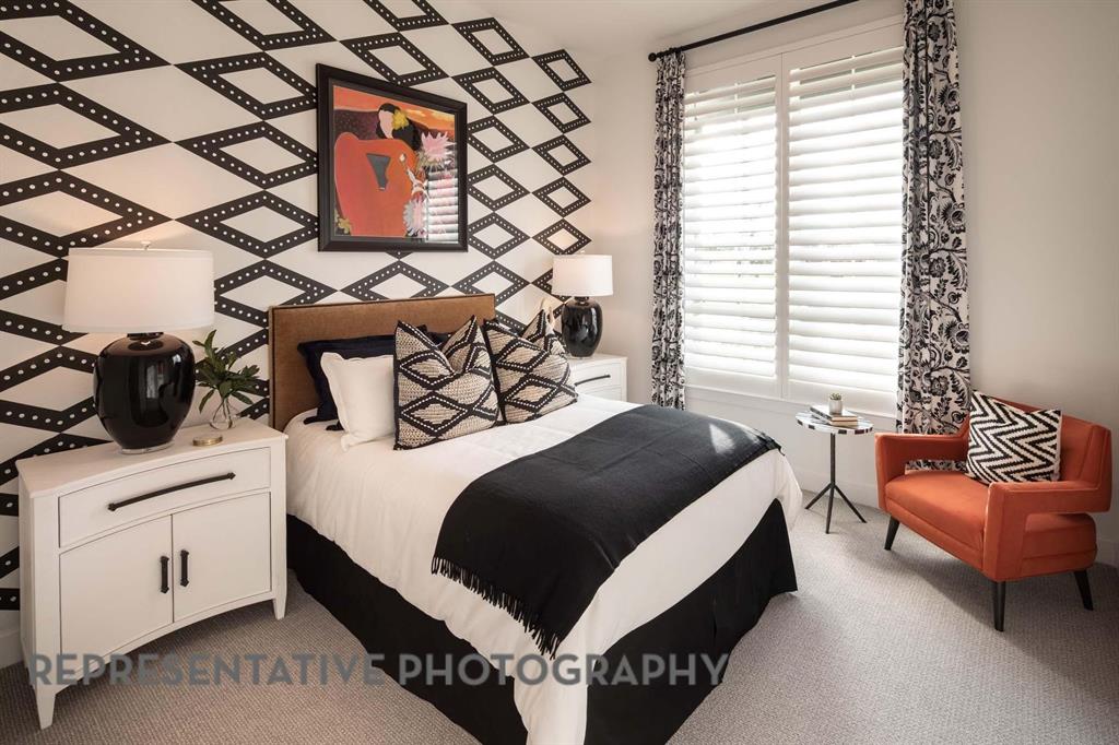 930 Heatherbrook Drive Prosper, TX 75078 - Photo 24 of 37 a bedroom with a bed and a couch