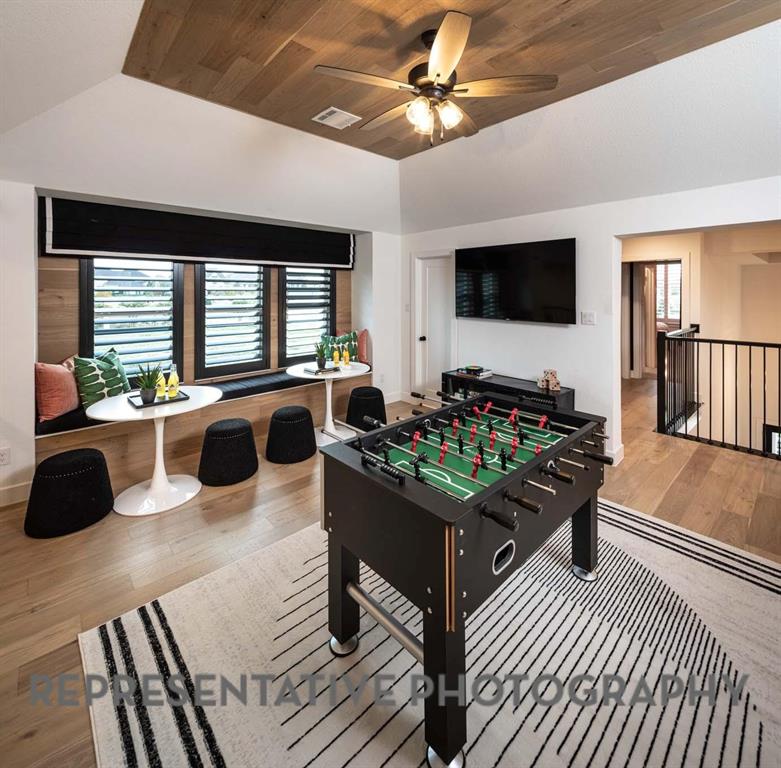 930 Heatherbrook Drive Prosper, TX 75078 - Photo 32 of 37 a living room with furniture a flat screen tv and a large window