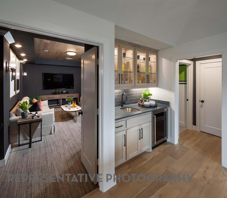 930 Heatherbrook Drive Prosper, TX 75078 - Photo 35 of 37 a kitchen with stainless steel appliances kitchen island granite countertop a stove a sink and a refrigerator