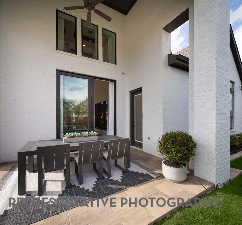 930 Heatherbrook Drive Prosper, TX 75078 - Photo 37 of 37 a living room with a couch and potted plant