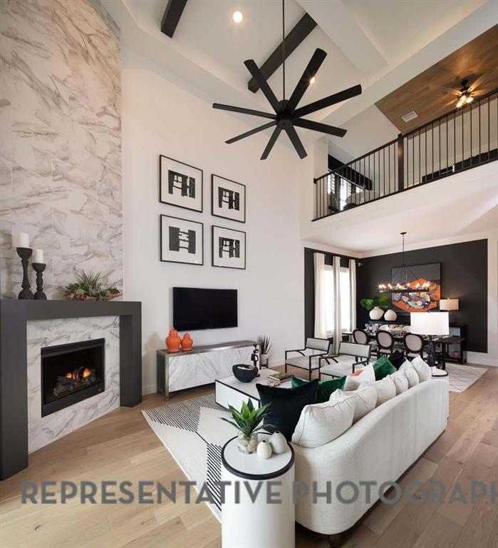 930 Heatherbrook Drive Prosper, TX 75078 - Photo 8 of 37 a living room with furniture and a fireplace