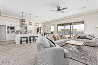 23109 West Skinner Road Wittmann, AZ 85361 - Photo 11 of 39 a living room with lots of furniture and a large window