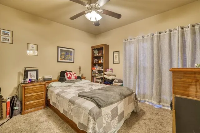 a bedroom with bed and a chandelier