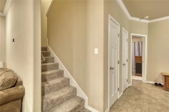 a view of a hallway with wooden floor and entryway