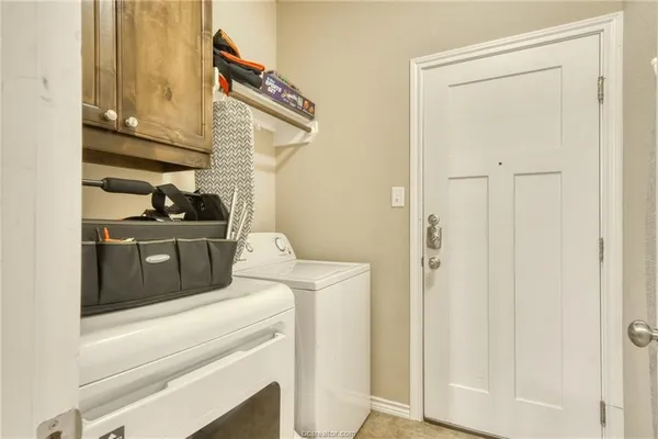 a kitchen with a stove and a white cabinet