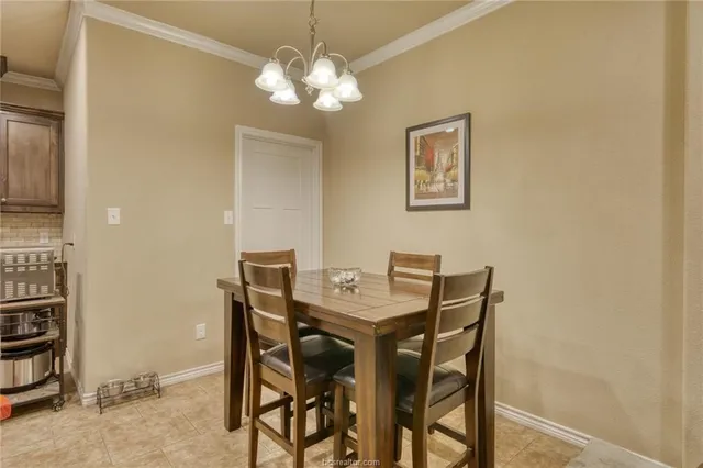 a view of a dining room with furniture and chandelier