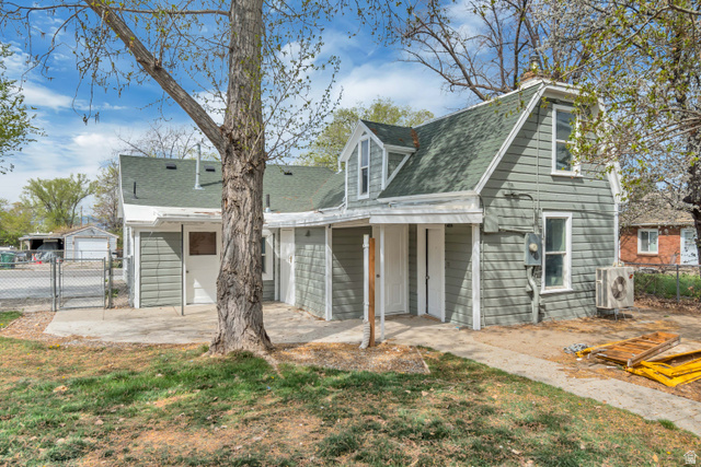 8831 South 400 East Sandy, UT 84070 - Photo 8 of 26 Back of house with a gate, roof with shingles, and a porch