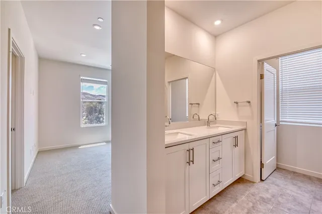 a bathroom with a granite countertop sink a large mirror and a