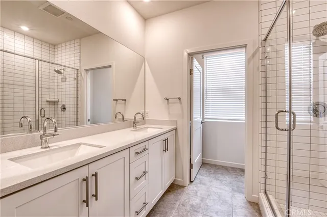 a bathroom with a double vanity sink and a mirror