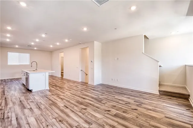 a view of kitchen with furniture and wooden floor