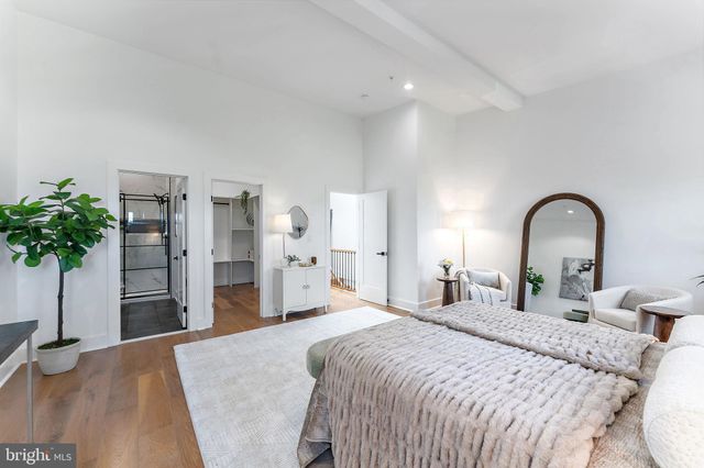 a bedroom with bed and a potted plant