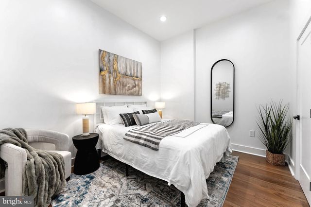 a bedroom with bed and a potted plant