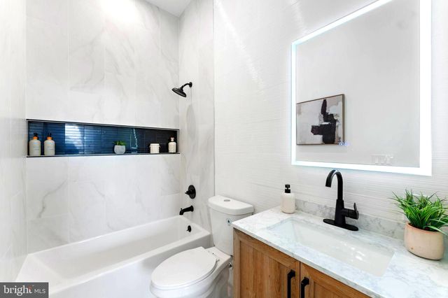 a bathroom with a sink a toilet and bathtub